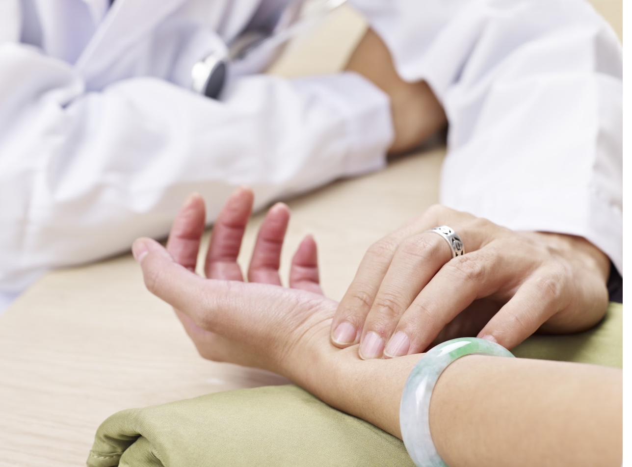 Traditional Chinese Medicine pulse diagnosis - Dr Reece Yeo examining patient's wrist pulse